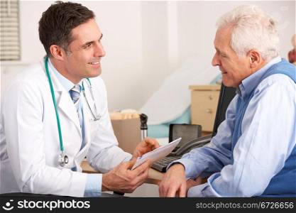 American doctor talking to senior man in surgery