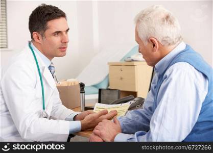 American doctor talking to senior man in surgery