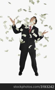 American dollar bills raining down on a businessman