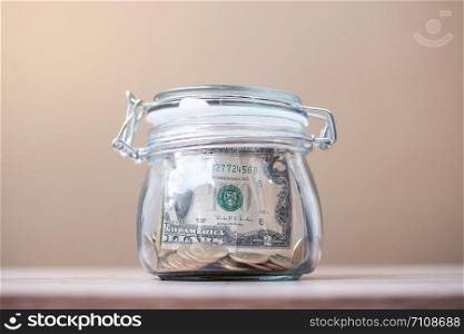 American dollar money in glass jar. world saving day, business, investment, retirement planning, finance concept