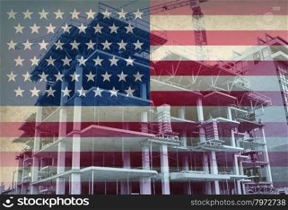 American Economic Development business and industry concept with the flag of the United States and a construction site with a concrete structure in the process of being built with a tower crane as a commercial real estate building.