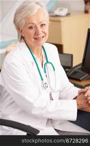 American female doctor sitting at desk