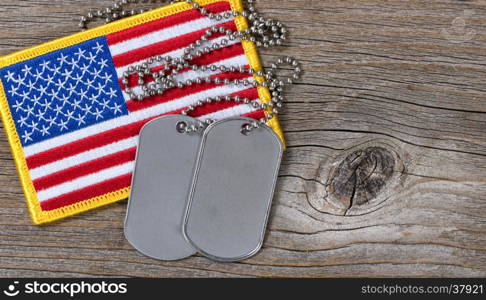 American flag and dog tags on rustic wood background