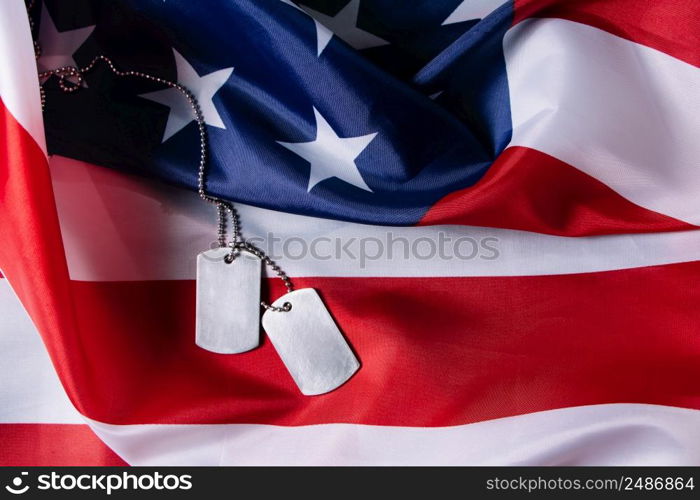 American flag and military dog tags close up. USA Memorial Day concept.. American flag and military dog tags close-up. USA Memorial Day concept.