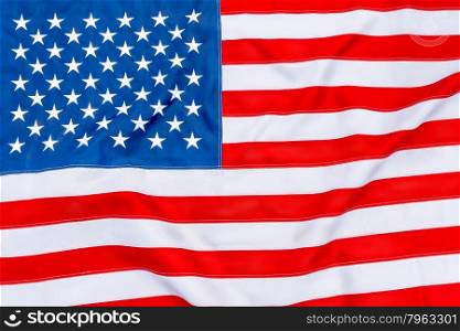 American flag fills the frame completely and fluttering in the wind