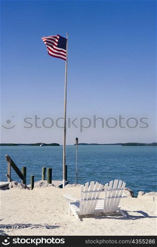 American flag fluttering on the beach