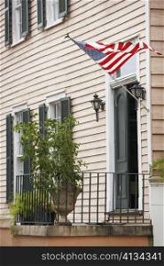 American flag fluttering on the entrance of a building, Savannah, Georgia, USA