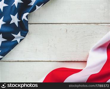 American Flag lying on an empty table. Place for your inscription. Beautiful card. Closeup, view from above. National holiday concept. Congratulations for family, relatives, friends and colleagues. American Flag lying on an empty table