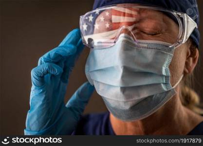 American Flag Reflecting on Distressed Female Medical Worker Wearing Protective Face Mask and Goggles.