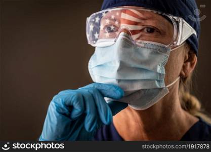 American Flag Reflecting on Female Medical Worker Wearing Protective Face Mask and Goggles.