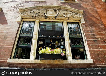 American flag with plants in a window box, Boston, Massachusetts, USA