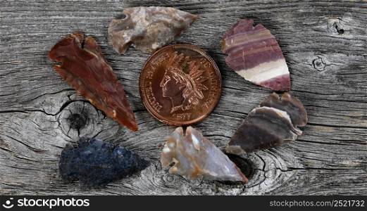 American flint arrowheads on rustic wood surface for a vintage concept
