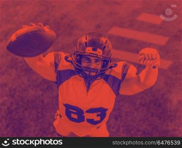 american football player celebrating touchdown isolated on stadium field. american football player celebrating touchdown