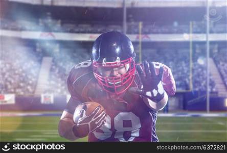 American football player holding ball while running on field of big modern american football stadium with lights and flares at night