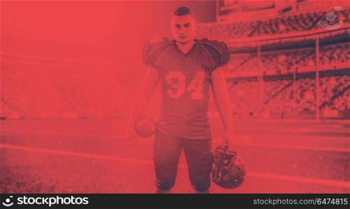 American Football Player isolated on big modern stadium field with lights and flares. American Football Player isolated on big modern stadium field