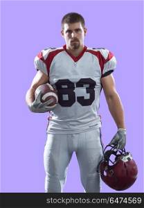 American Football Player isolated on colorfull background. Portrait of a strong muscular American Football Player isolated on colorful background