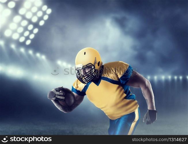 American football player with ball in hands, on sport arena. National league. American football player with ball on sport arena