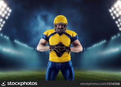 American football player with ball on the stadium. National league, men sport. American football player with ball on the stadium