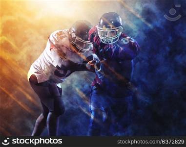 American football players in action at night game time on the field with flame effects and particles