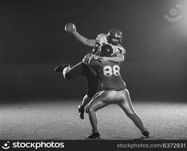 American football players in action at night game time on the field