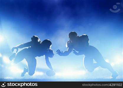 American football players in game, touchdown. Night stadium lights