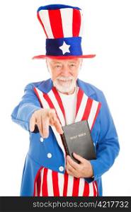 American icon Uncle Sam holding a bible and pointing at you. Isolated on white.