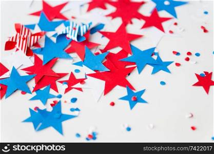 american independence day, celebration and holidays concept - close up of red and blue paper star decorations and confetti on 4th july theme party on white background. paper star confetti decoration on independence day