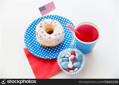 american independence day, celebration, patriotism and holidays concept - close up of glazed sweet donut with juice and candies in disposable tableware at 4th july party from top