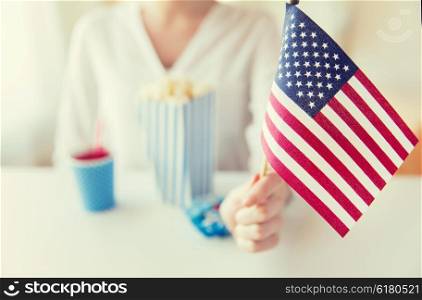 american independence day, celebration, patriotism and holidays concept - close up of woman hand holding flag at 4th july party