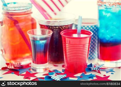 american independence day, celebration, patriotism and holidays concept - close up of cups and glasses with drinks on american independence day party