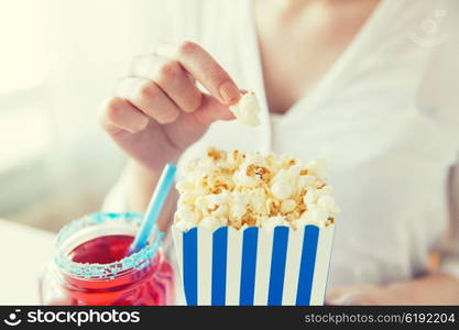 american independence day, celebration, patriotism and holidays concept - close up of woman eating popcorn with drink in glass mason jar at 4th july party