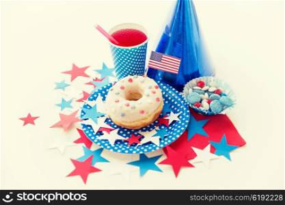 american independence day, celebration, patriotism and holidays concept - close up of glazed sweet donut with juice and candies in disposable tableware at 4th july party