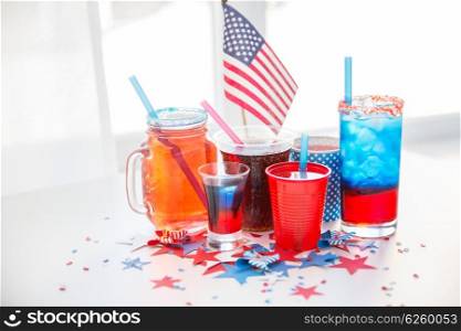 american independence day, celebration, patriotism and holidays concept - close up of drinks in cups and glasses with american flag on independence day party