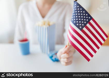 american independence day, celebration, patriotism and holidays concept - close up of woman hand holding flag at 4th july party