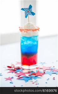 american independence day, celebration, patriotism and holidays concept - glass of cocklatil drink with whipped cream and pinwheel decoration on american independence day party