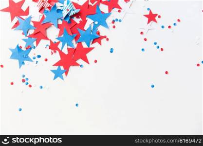 american independence day, celebration, patriotism and holidays concept - red and blue paper stars confetti on american independence day party