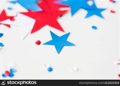 american independence day, celebration, patriotism and holidays concept - red and blue paper stars confetti on american independence day party