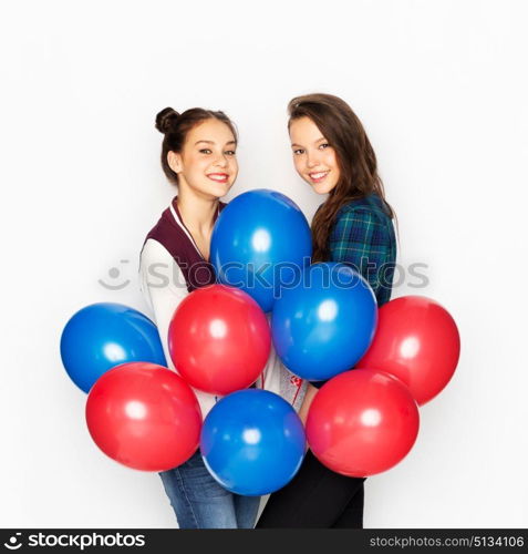 american independence day, holiday and birthday party concept - happy smiling pretty teenage girls with red and blue helium balloons over white background. happy teenage girls with helium balloons