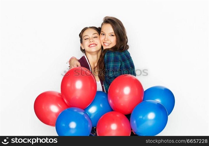 american independence day, holiday and birthday party concept - happy smiling pretty teenage girls with red and blue helium balloons over white background. happy teenage girls with helium balloons