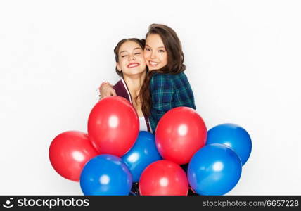 american independence day, holiday and birthday party concept - happy smiling pretty teenage girls with red and blue helium balloons over white background. happy teenage girls with helium balloons