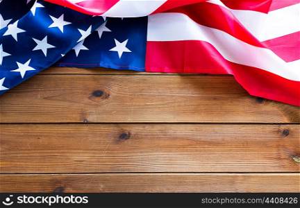 american independence day, patriotism, national and memorial concept - close up of american flag on wooden boards with copy space