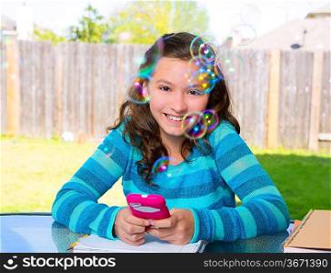 American latin teen girl with smartphone doing homework on backyard