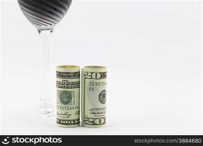 American money placed with stem glass filled with red wine; copy space on right;