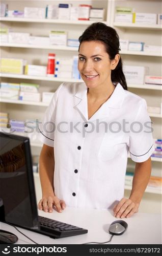 American pharmacist using computer in pharmacy