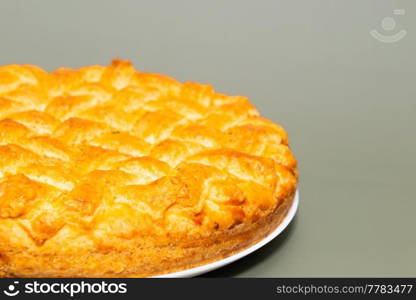 American pie with baked crust on gray background
