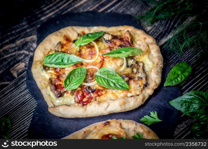 American pizza with mozzarella, tomato, pepperoni on dark wooden table. Sliced pepperoni pizza topping. American pizza on wooden board and various ingredients. American style pizzerias.