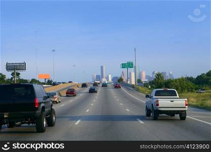 American road way to Houston city downtown with car traffic
