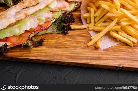 American sandwich baguett with ham steak and french fries