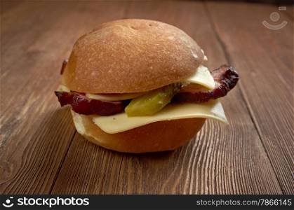 american sandwich with bacon, cheese and cucumber