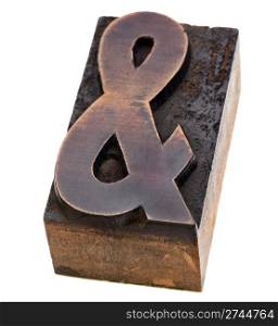 ampersand symbol - a vintage wood letterpress type block, stained by black ink, isolated on white